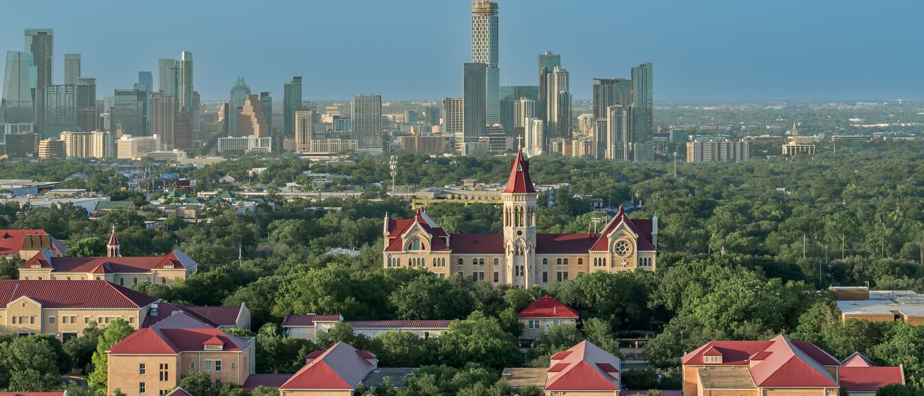 St. Edward's University campus from the air, downtown Austin skyline on the horizon