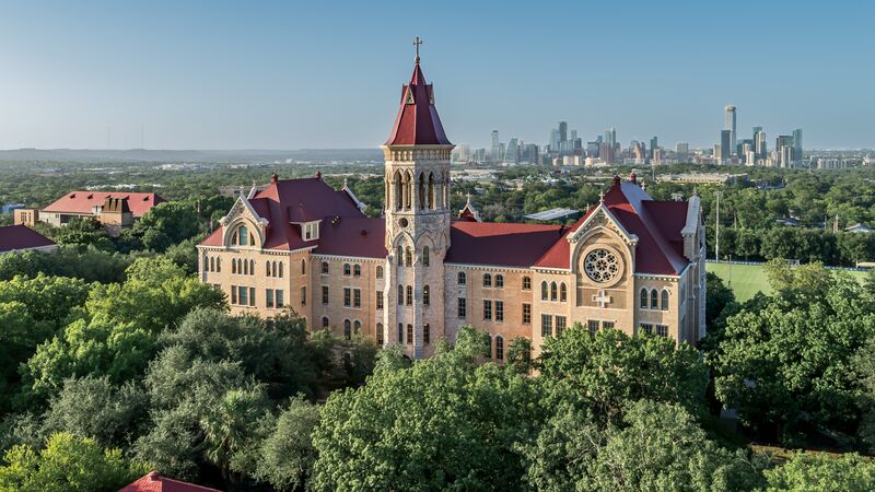 St. Edward's University main building with the Austin skyline behind